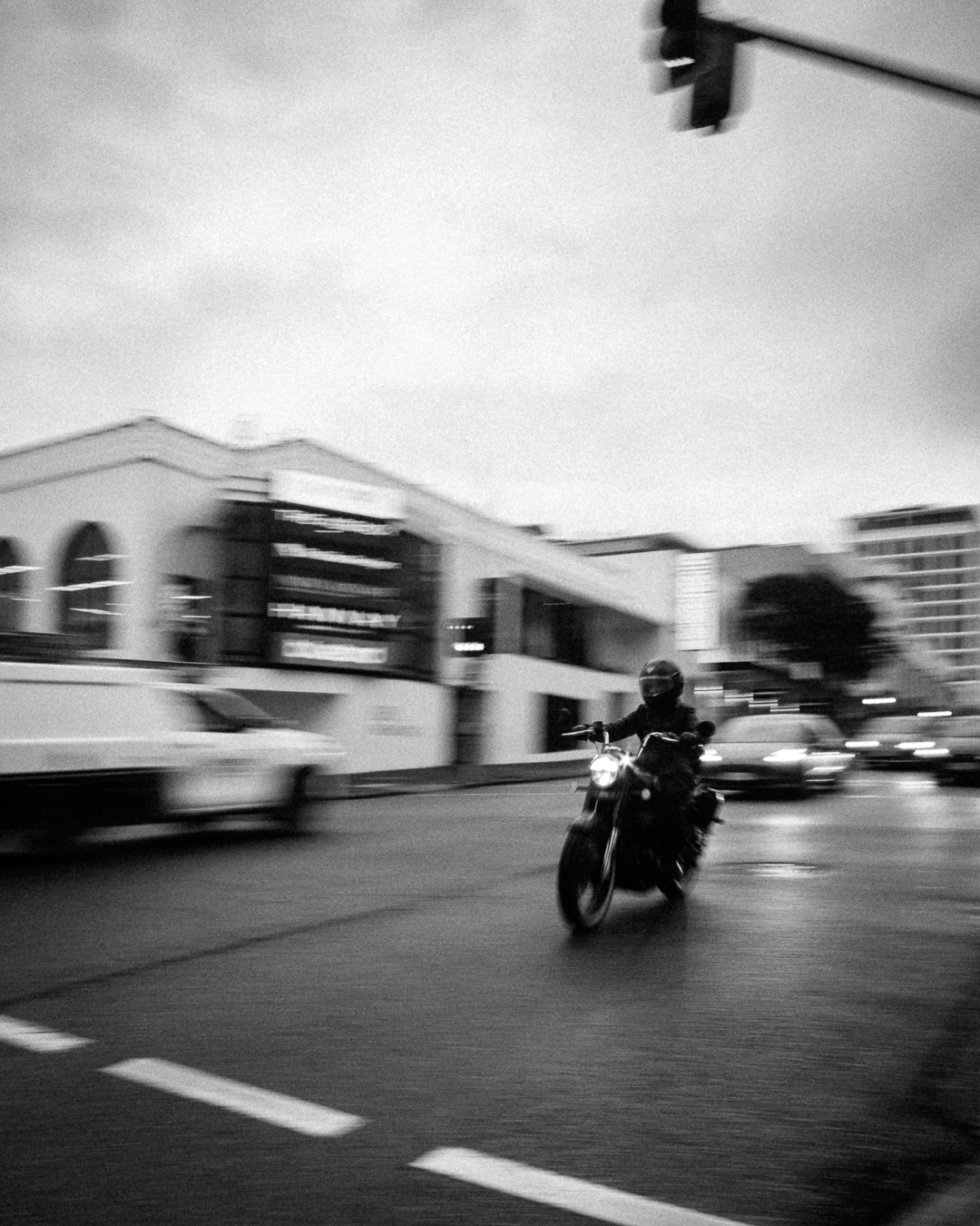 Black and white motion-blur motorcycle shot outside on Brunswick Street